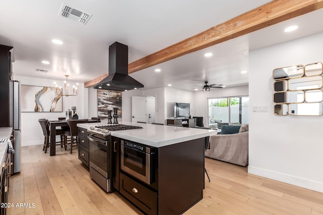 kitchen with appliances with stainless steel finishes, light wood-type flooring, exhaust hood, and a center island