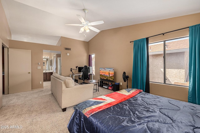 carpeted bedroom featuring visible vents, vaulted ceiling, connected bathroom, and ceiling fan