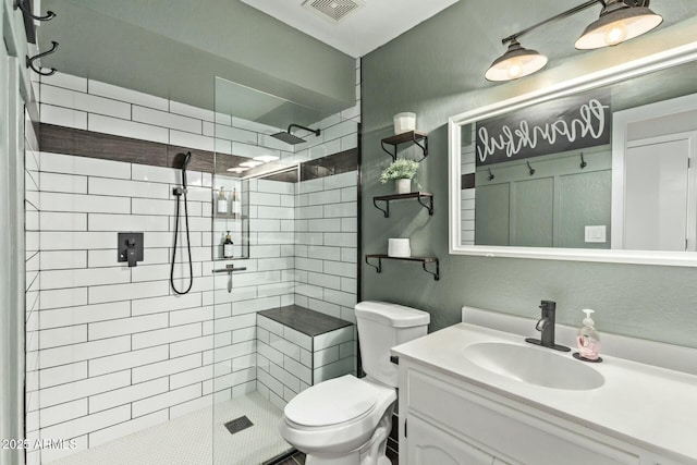 full bathroom featuring toilet, visible vents, and a tile shower