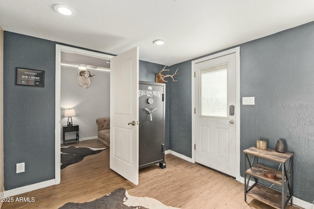 laundry area featuring baseboards and wood finished floors