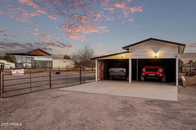 exterior space featuring a carport, concrete driveway, and fence