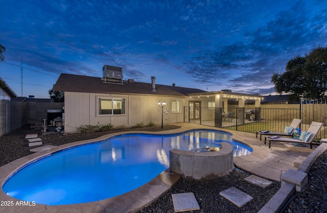 view of pool featuring central AC unit, a patio, a fenced backyard, and a fenced in pool