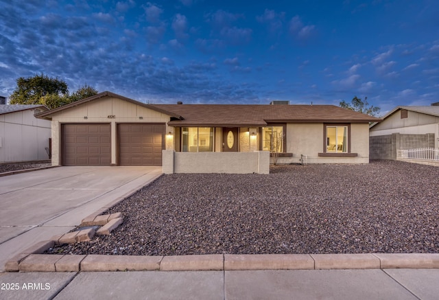 single story home with driveway, an attached garage, and fence