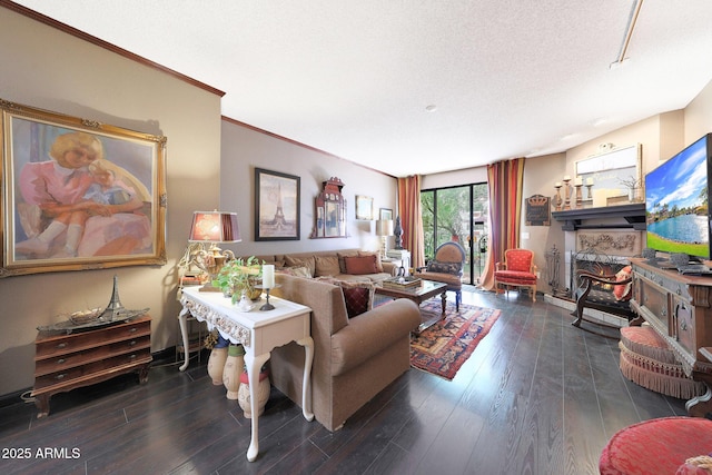 living area with wood finished floors, a textured ceiling, and crown molding