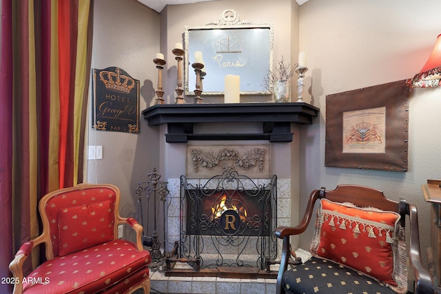 sitting room with a warm lit fireplace