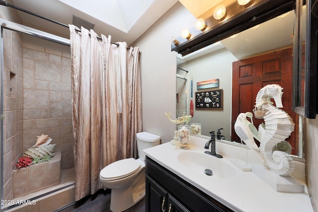 bathroom featuring a shower stall, toilet, vanity, and wood finished floors