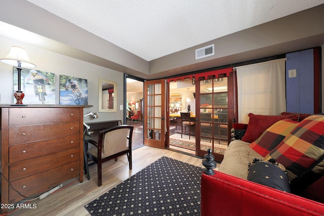 office area featuring french doors, wood finished floors, and a textured ceiling