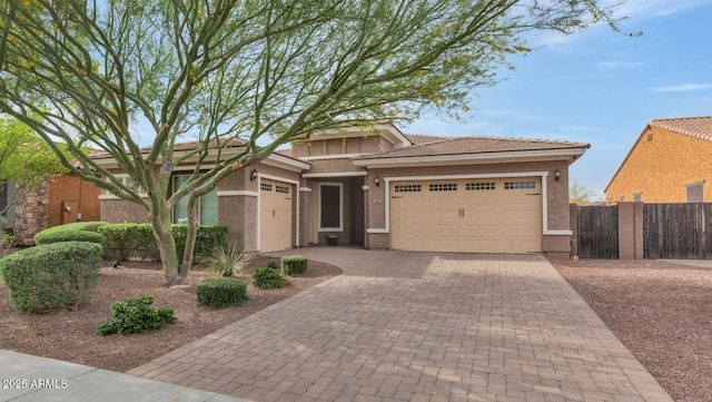 2605 W Desert Marigold Dr, Phoenix, AZ 85085 - prairie-style home featuring an attached garage, stucco siding, fence, and decorative driveway