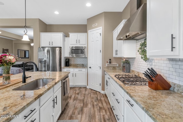 2605 W Desert Marigold Dr, Phoenix, AZ 85085 - kitchen featuring appliances with stainless steel finishes, a sink, wall chimney range hood, and white cabinets