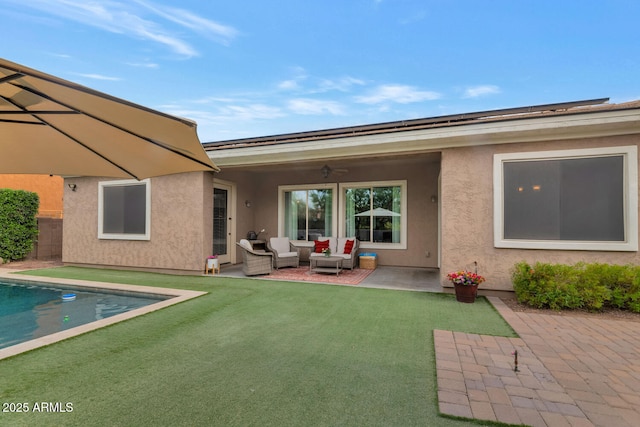 2605 W Desert Marigold Dr, Phoenix, AZ 85085 - rear view of house featuring a ceiling fan, a patio, an outdoor hangout area, and stucco siding