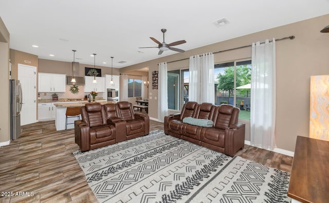 2605 W Desert Marigold Dr, Phoenix, AZ 85085 - living room featuring baseboards, recessed lighting, a ceiling fan, visible vents, and wood finished floors