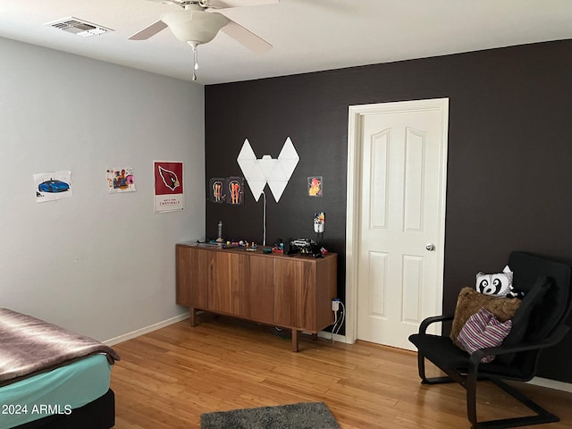 sitting room with ceiling fan and light hardwood / wood-style flooring