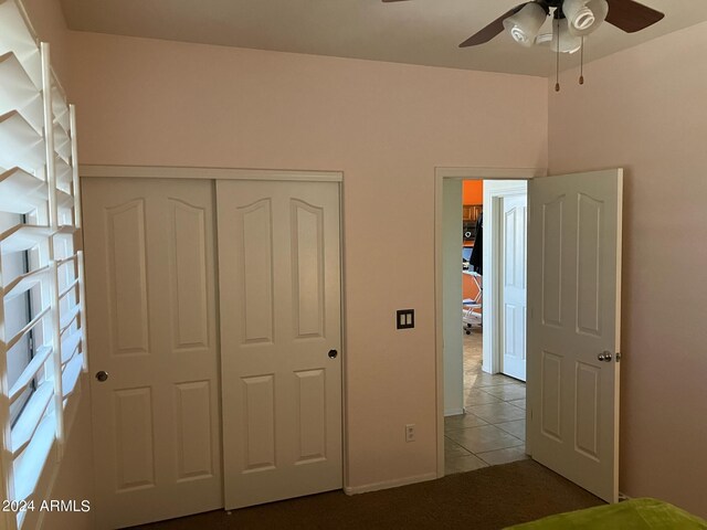 unfurnished bedroom featuring a closet, ceiling fan, and light tile patterned floors