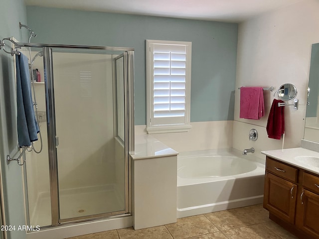 bathroom with independent shower and bath, vanity, and tile patterned floors