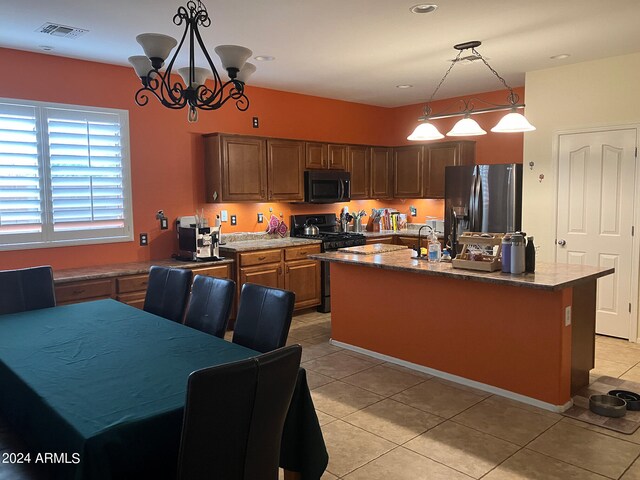 kitchen featuring a chandelier, range, stainless steel fridge with ice dispenser, a kitchen island, and light tile patterned floors