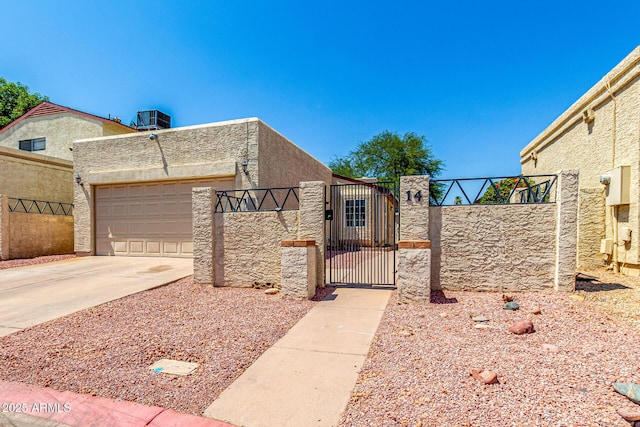 619 E Jensen St Unit 14, Mesa, AZ 85203 - view of front facade with a gate, concrete driveway, a garage, and stucco siding