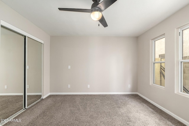 619 E Jensen St Unit 14, Mesa, AZ 85203 - unfurnished bedroom with carpet floors, a closet, and a ceiling fan