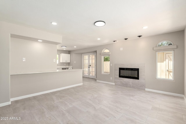 619 E Jensen St Unit 14, Mesa, AZ 85203 - unfurnished living room with a premium fireplace, healthy amount of natural light, recessed lighting, and french doors