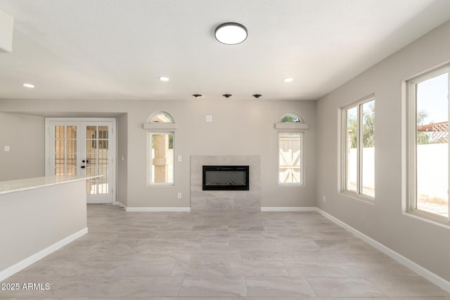619 E Jensen St Unit 14, Mesa, AZ 85203 - unfurnished living room featuring a tiled fireplace, french doors, and recessed lighting
