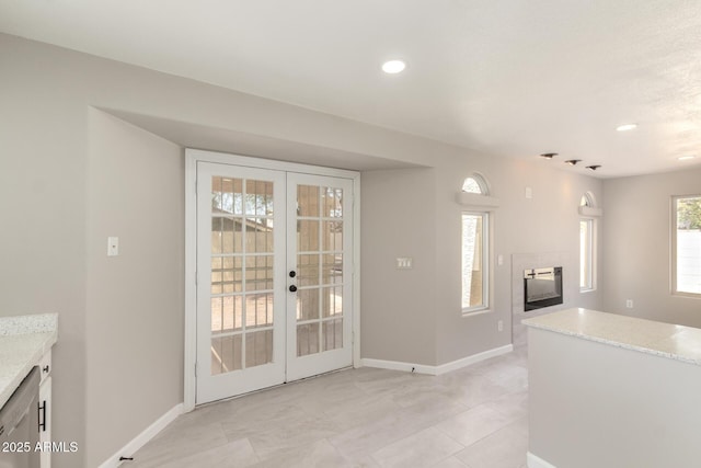 619 E Jensen St Unit 14, Mesa, AZ 85203 - kitchen with light stone counters, french doors, a tile fireplace, and recessed lighting