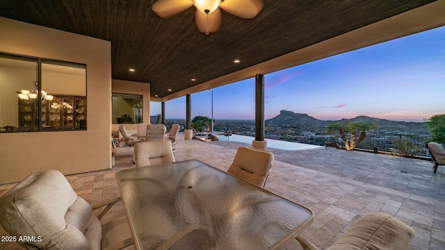 3168 S Yaqui Ln, Gold Canyon, AZ 85118 - patio terrace at dusk with a mountain view and ceiling fan