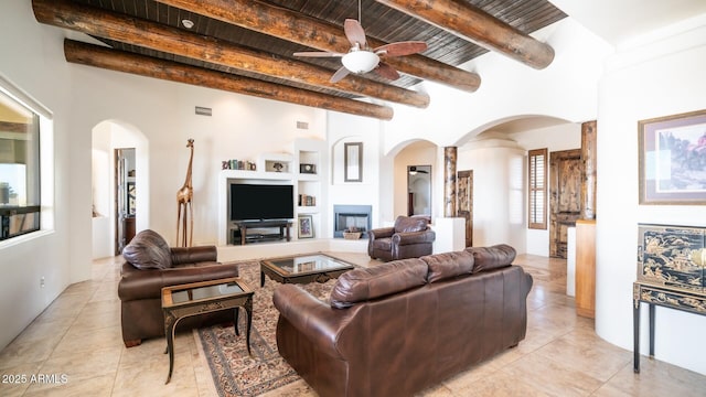 3168 S Yaqui Ln, Gold Canyon, AZ 85118 - living room featuring beamed ceiling, light tile patterned floors, built in features, and ceiling fan