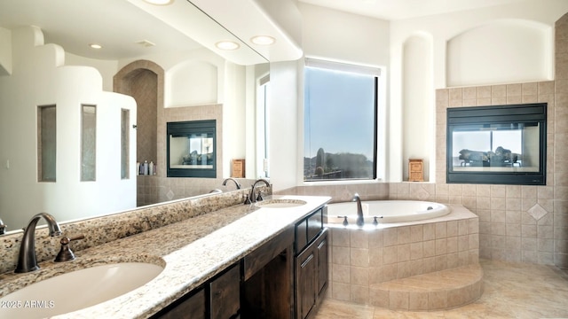 3168 S Yaqui Ln, Gold Canyon, AZ 85118 - bathroom featuring a tiled fireplace, vanity, and tiled bath
