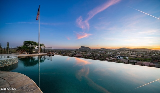 pool at dusk with a mountain view