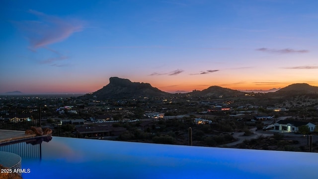 3168 S Yaqui Ln, Gold Canyon, AZ 85118 - pool at dusk featuring a water and mountain view