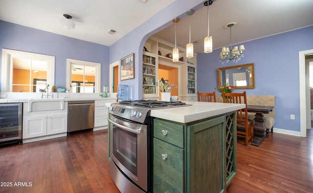 39 E Hoover Ave, Phoenix, AZ 85004 - kitchen with appliances with stainless steel finishes, a sink, dark wood-type flooring, and wine cooler