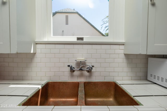 39 E Hoover Ave, Phoenix, AZ 85004 - kitchen with tile counters, a sink, white cabinetry, and backsplash