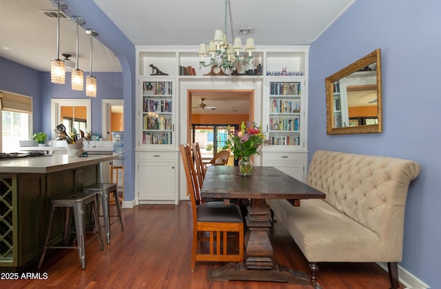 39 E Hoover Ave, Phoenix, AZ 85004 - dining area featuring an inviting chandelier, built in features, dark wood finished floors, and arched walkways