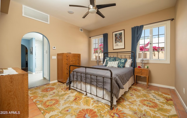 39 E Hoover Ave, Phoenix, AZ 85004 - tiled bedroom with arched walkways, baseboards, a ceiling fan, and visible vents