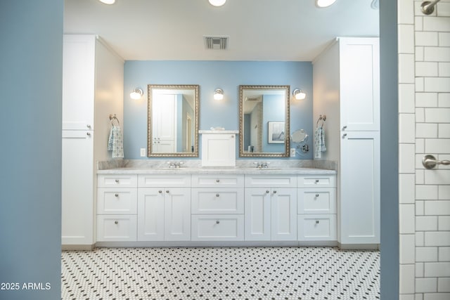 39 E Hoover Ave, Phoenix, AZ 85004 - bathroom with double vanity, recessed lighting, a sink, and visible vents