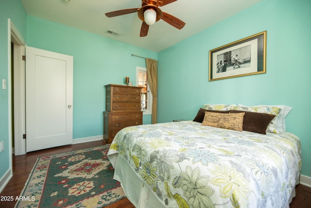39 E Hoover Ave, Phoenix, AZ 85004 - bedroom featuring baseboards, ceiling fan, wood finished floors, and visible vents