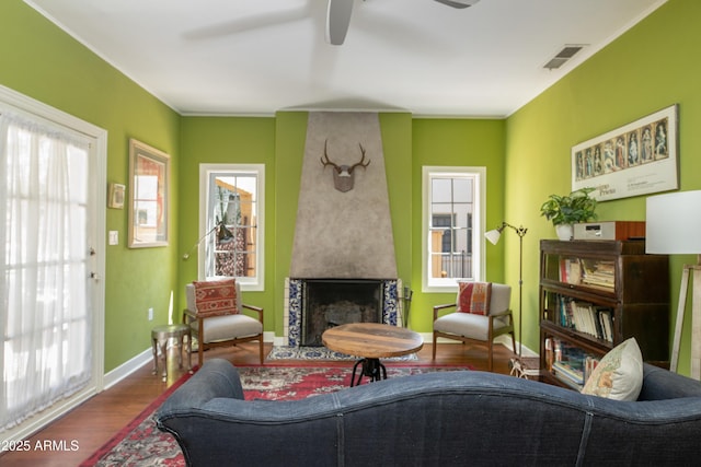 39 E Hoover Ave, Phoenix, AZ 85004 - sitting room with plenty of natural light, a ceiling fan, visible vents, a fireplace, and wood finished floors