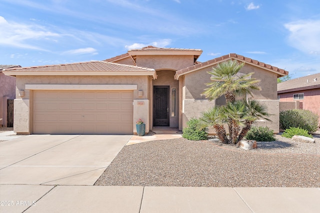 1819 W Deer Creek Rd, Phoenix, AZ 85045 - mediterranean / spanish-style house with concrete driveway, an attached garage, and stucco siding