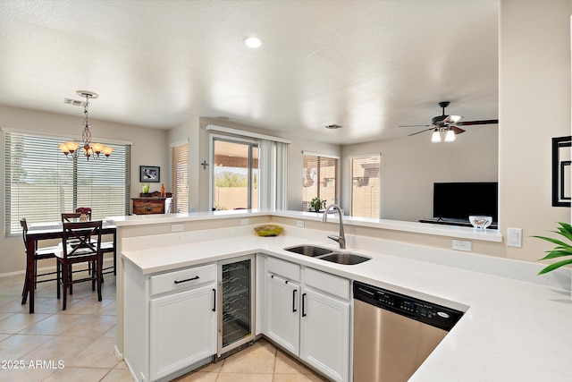 1819 W Deer Creek Rd, Phoenix, AZ 85045 - kitchen with stainless steel dishwasher, wine cooler, a sink, light tile patterned flooring, and light countertops