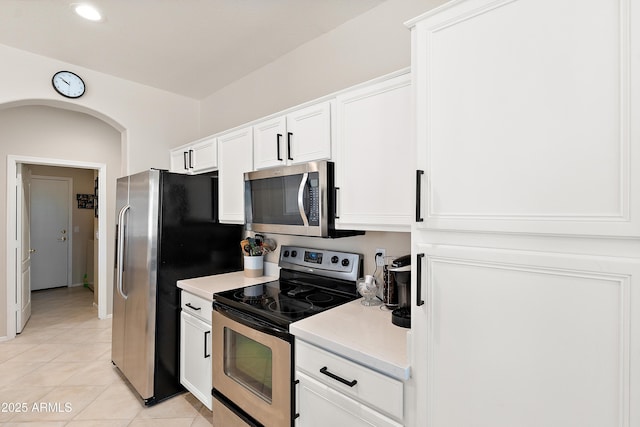 1819 W Deer Creek Rd, Phoenix, AZ 85045 - kitchen featuring appliances with stainless steel finishes, light tile patterned floors, white cabinetry, and recessed lighting