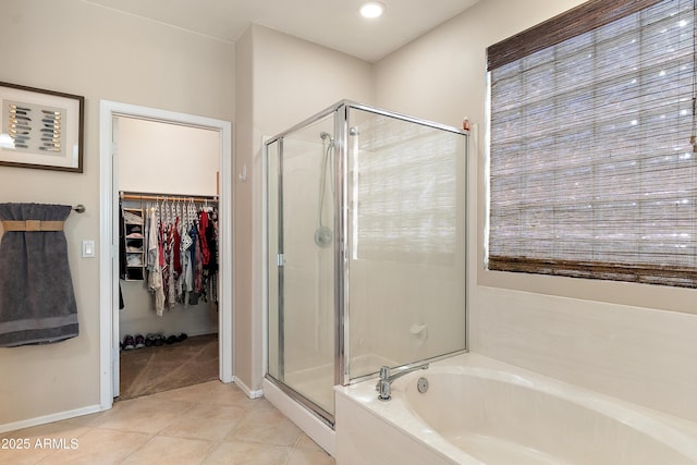 1819 W Deer Creek Rd, Phoenix, AZ 85045 - full bath featuring a stall shower, a bath, tile patterned flooring, a spacious closet, and baseboards