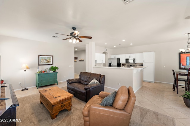 1819 W Deer Creek Rd, Phoenix, AZ 85045 - living room with light tile patterned flooring, a ceiling fan, recessed lighting, baseboards, and a chandelier