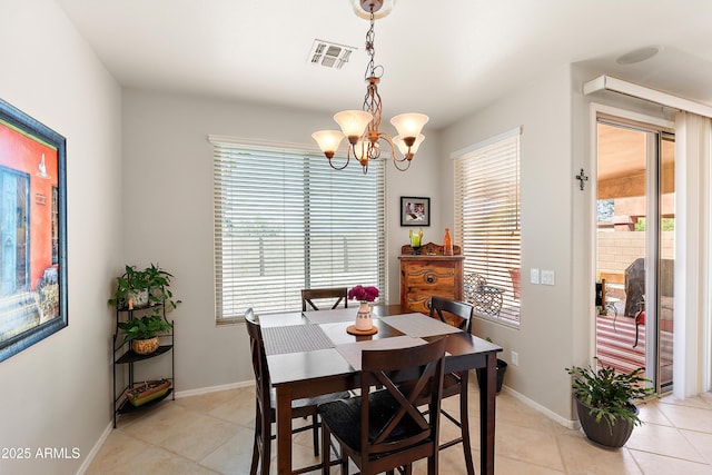 1819 W Deer Creek Rd, Phoenix, AZ 85045 - dining space with a chandelier, light tile patterned floors, and baseboards