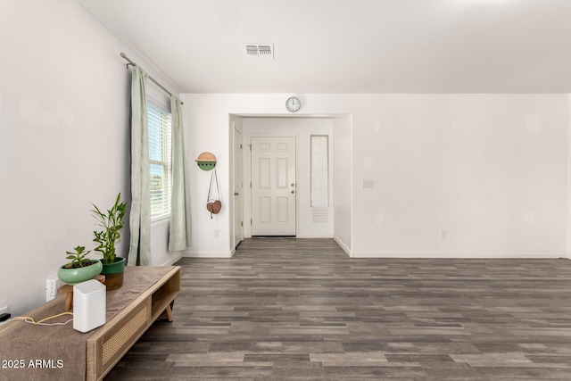 entryway featuring baseboards, visible vents, and dark wood finished floors