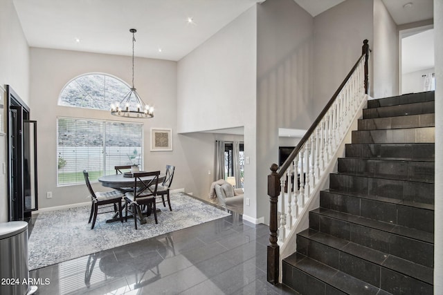 dining area featuring a high ceiling and an inviting chandelier