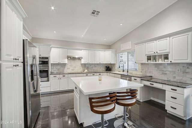 kitchen with white cabinetry and vaulted ceiling