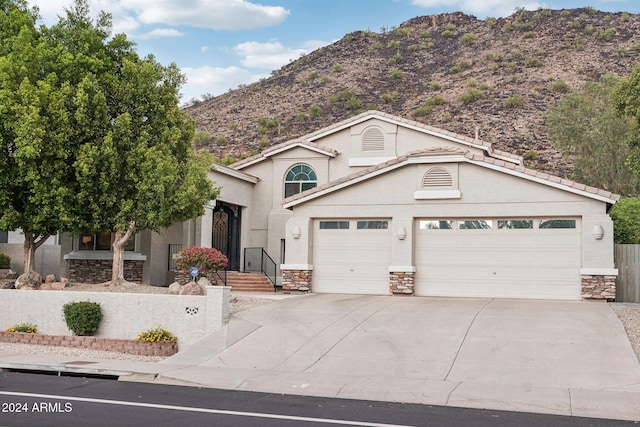 view of front property featuring a mountain view and a garage