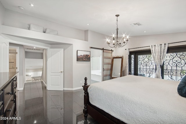 bedroom featuring a chandelier, a barn door, and connected bathroom