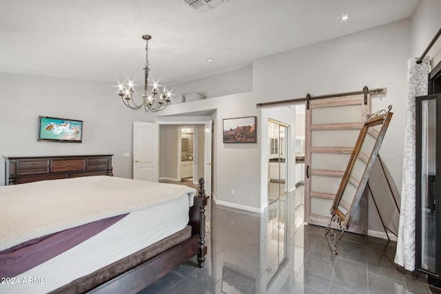 bedroom featuring a barn door and a chandelier