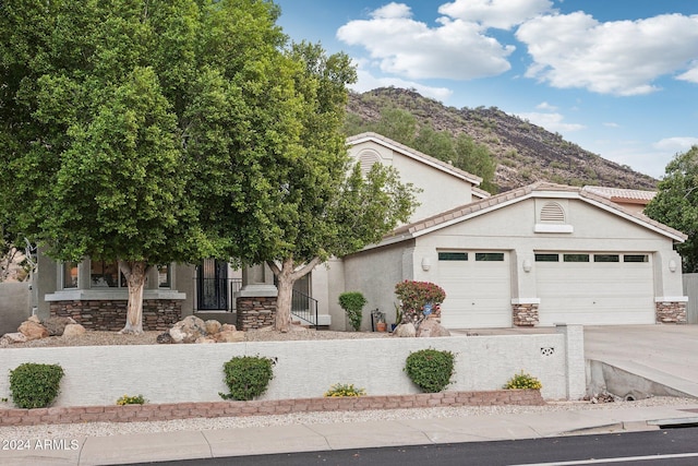 view of front of home with a mountain view and a garage