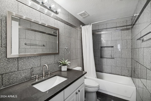 full bathroom with a textured ceiling, shower / bath combination with curtain, and tile walls